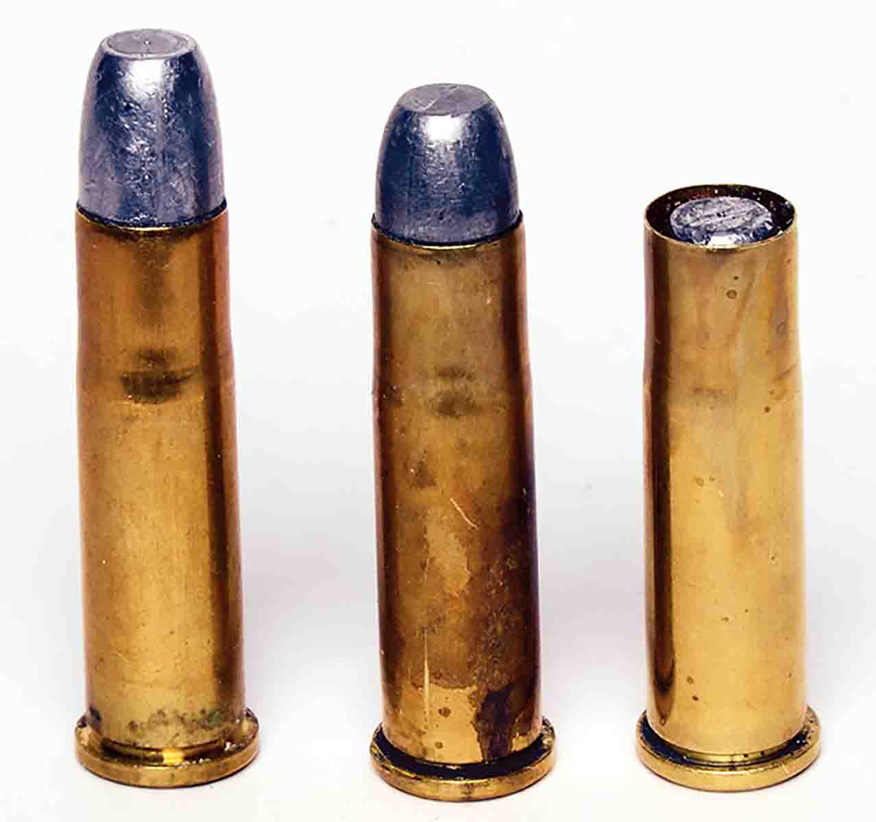 This shows what happened with cast bullets used in tubular magazine lever guns if they are not properly crimped in place. At left is a normal round. The middle round shows the bullet pushed back when five rounds were loaded in the magazine. The far right round happened when the first shot was fired.